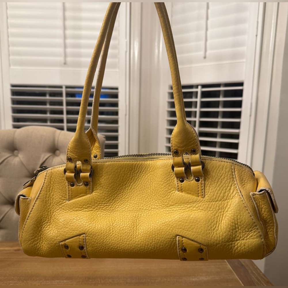 Cole Haan Y2K Pebble Leather Barrel Handbag with magnetic flap end pockets.